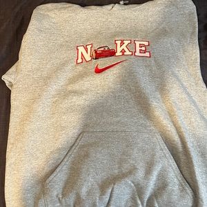 Medium men’s Nike hoodie with lighting McQueen in place of the “i”